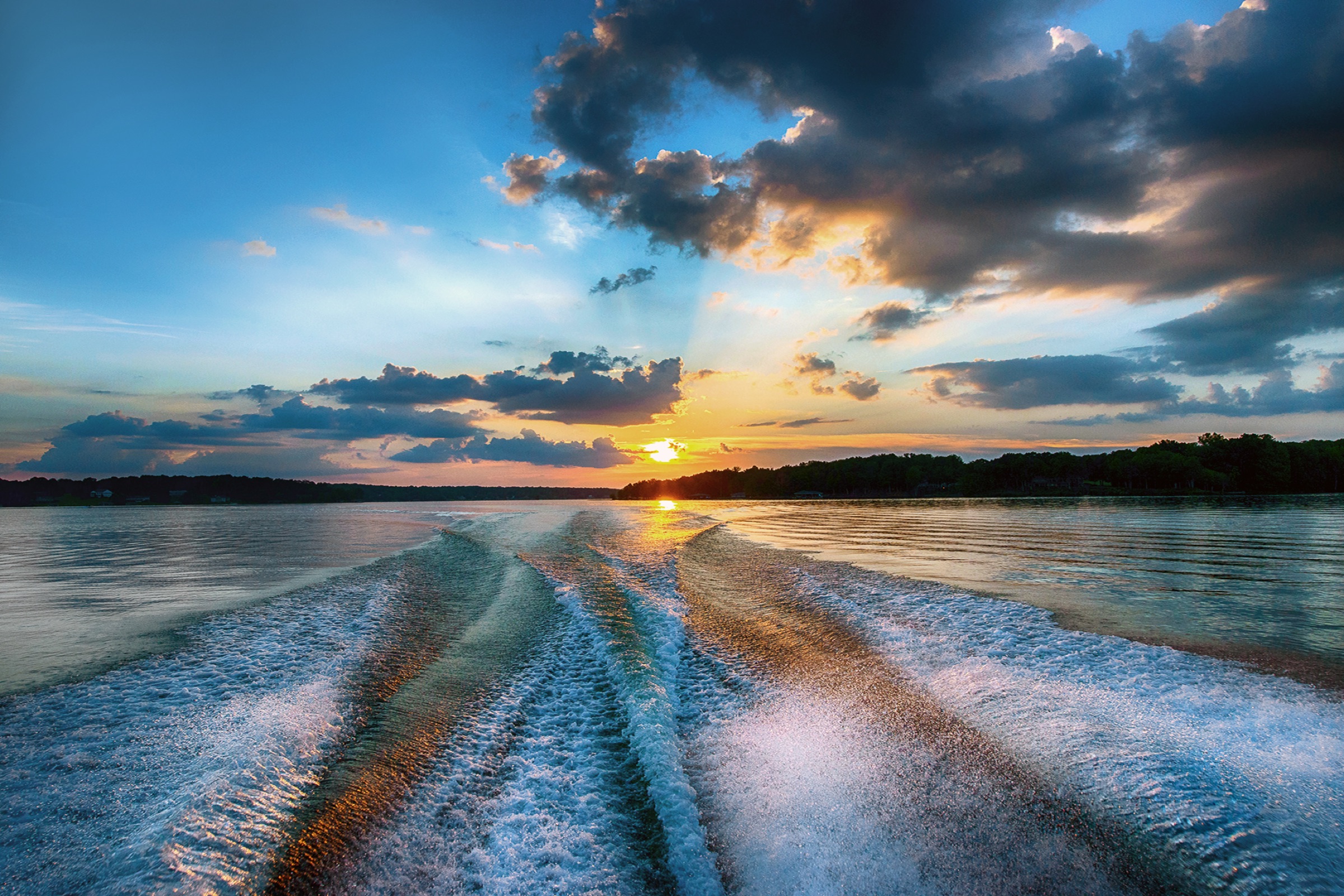 Boat wake at sunset on Lake Anna